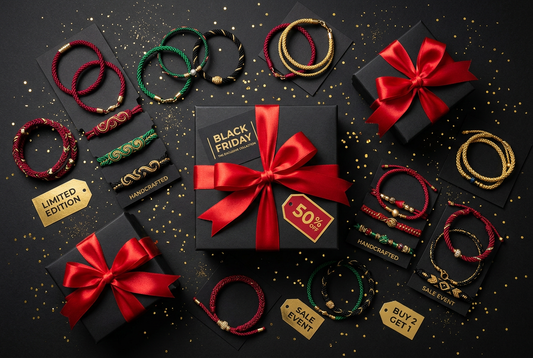 Luxury Black Friday handmade jewelry shopping flat-lay with matte black gift boxes, red ribbons, and vibrant braided cord bracelets