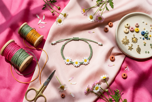 Modern chic vibrant pink flat-lay of handcrafted daisy floral braided bracelet with colorful cords and DIY kit materials