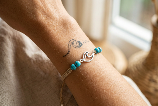 Delicate minimalist Taoist fine line tattoo stacked with bright sky blue turquoise and 925 silver talisman cord bracelet