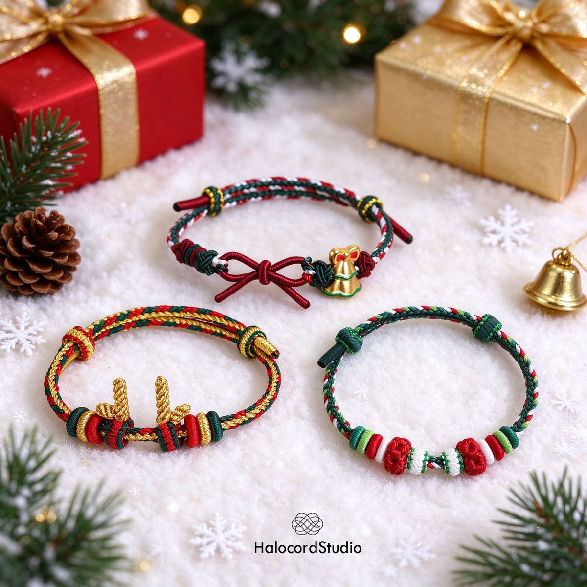 Three handmade Christmas cord bracelets in snow with red and gold holiday gift boxes and evergreen pine branches