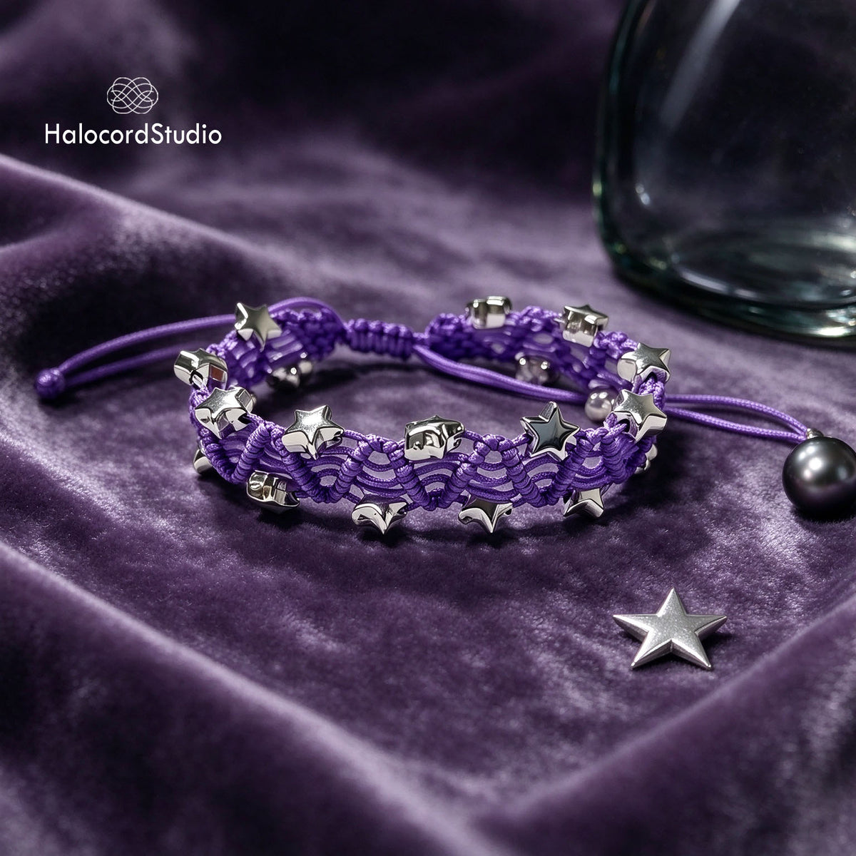 Purple handmade star charm bracelet featuring intricate woven wave lace and silver star beads on purple velvet